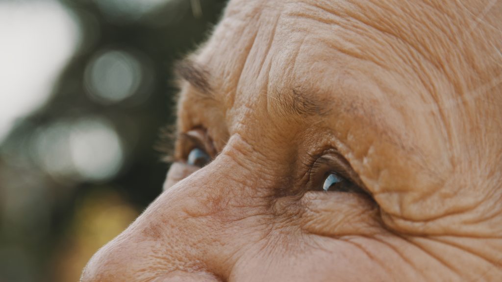 A close up of an older person’s eyes looking up.